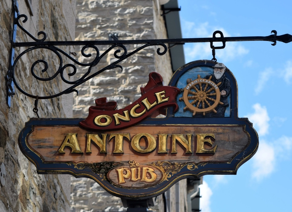 A sign for antoine pub in the french city of oncle.
