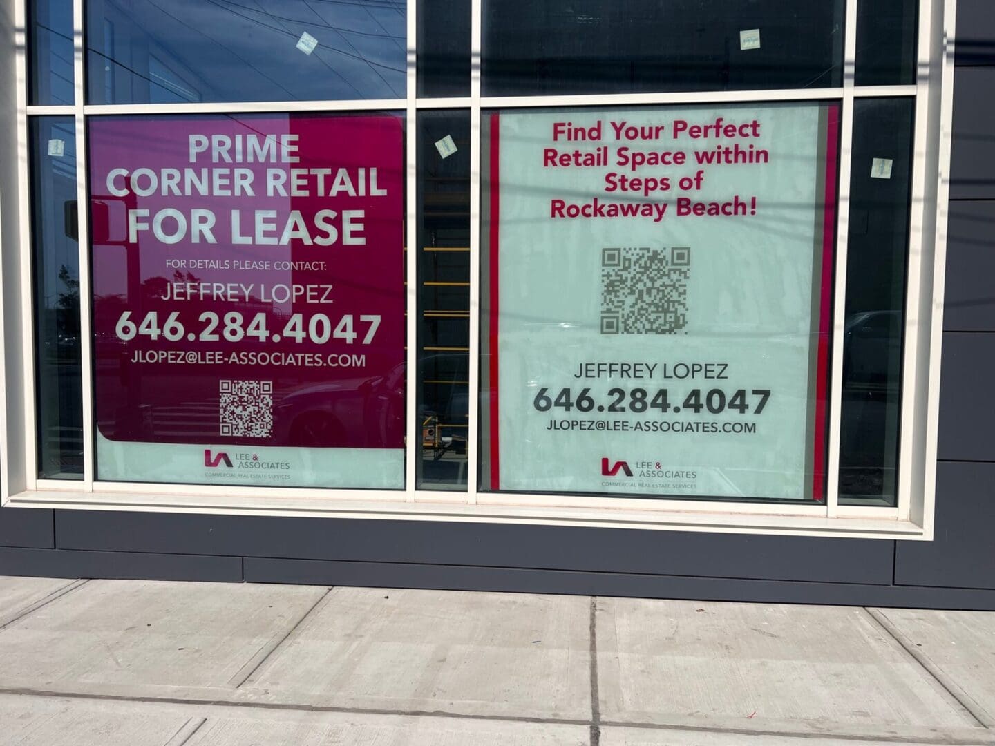 A building with two windows and a qr code on the window.