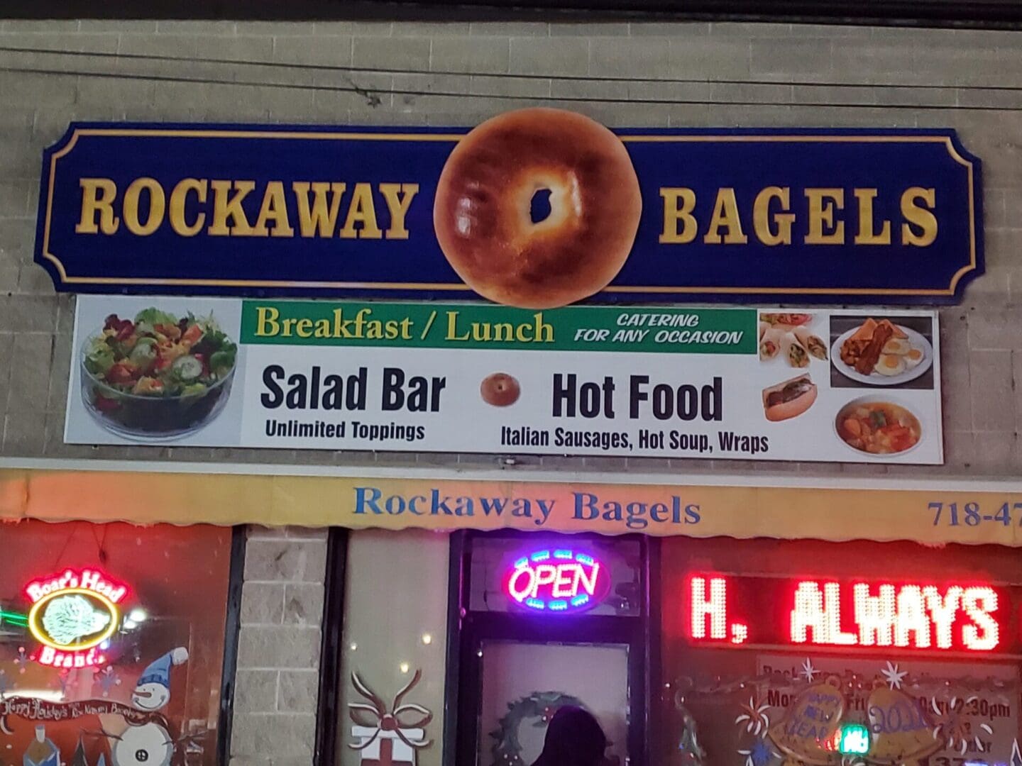 A sign for rockaway bagels in front of the building.
