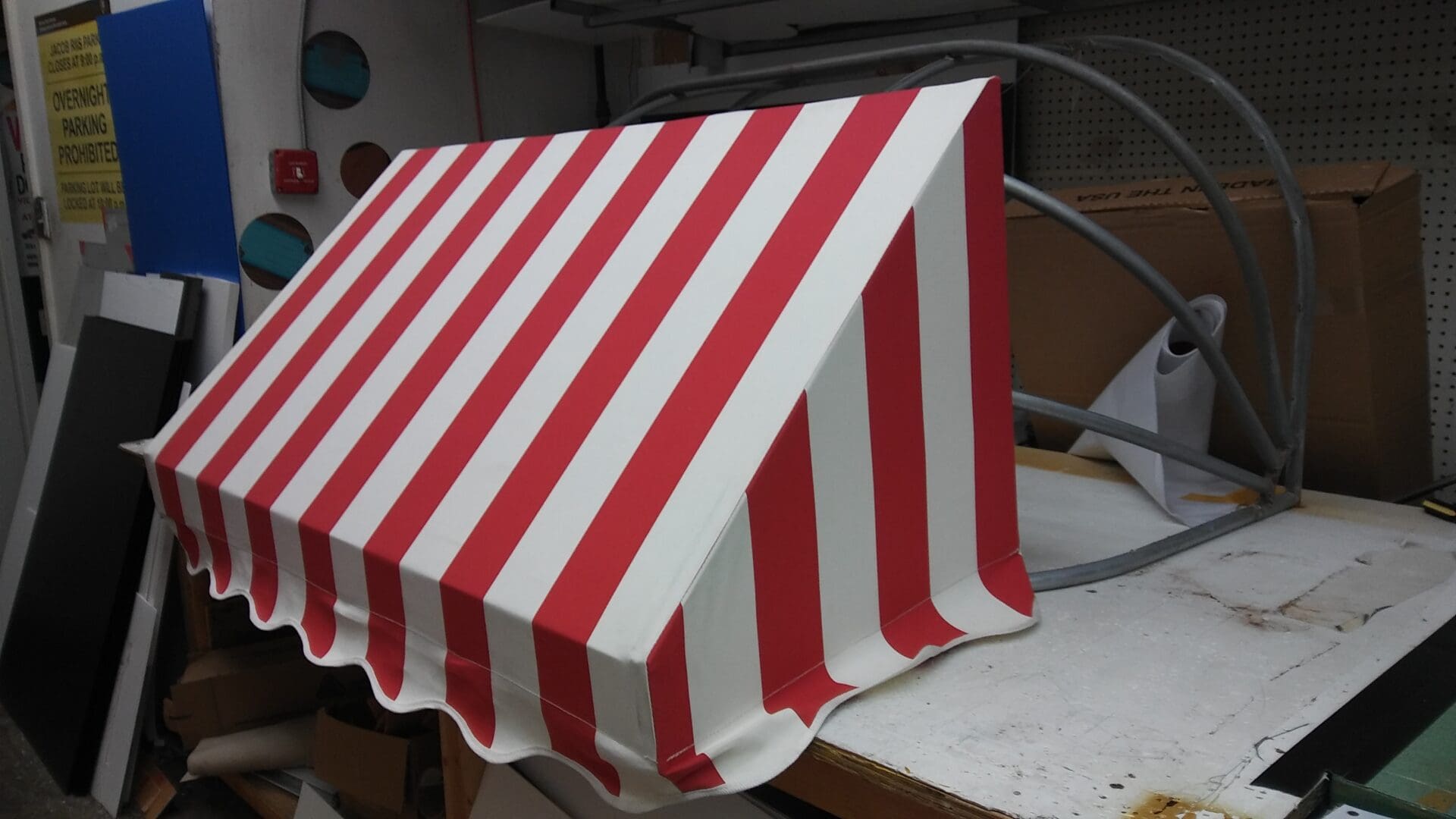 A red and white striped awning on a worktable in the ADP USA Solutions Gallery.