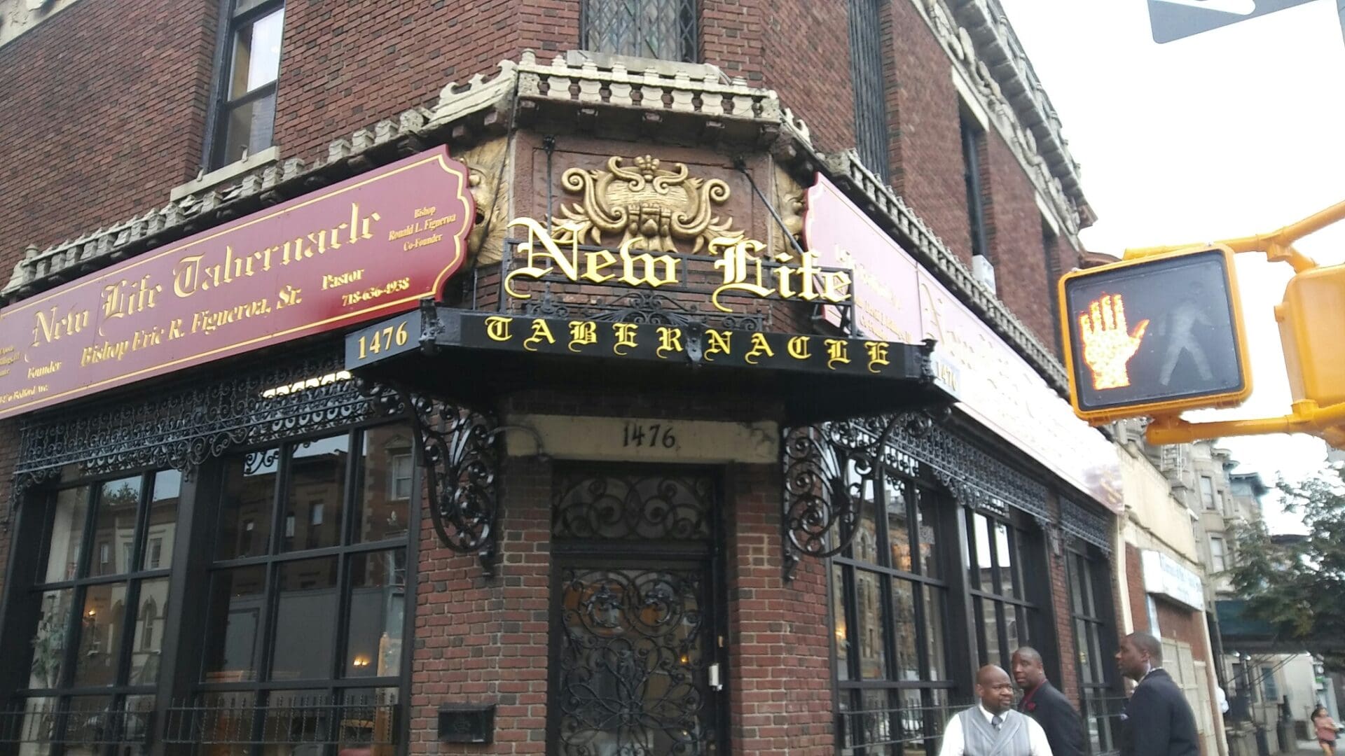 Exterior of the historic Neir's Tavern in Queens, New York, featuring intricate signage and two people chatting by the entrance, captured by ADP USA Solutions Gallery.